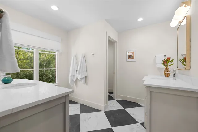 a kitchen with a sink a refrigerator and a window