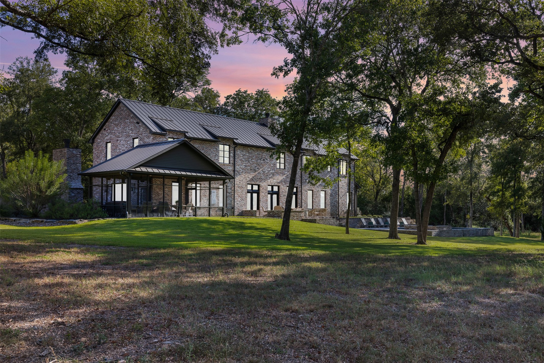 565 Bybee Road Round Top, TX 78954 - Photo 26 of 30 a view of a big house with a big yard and large trees