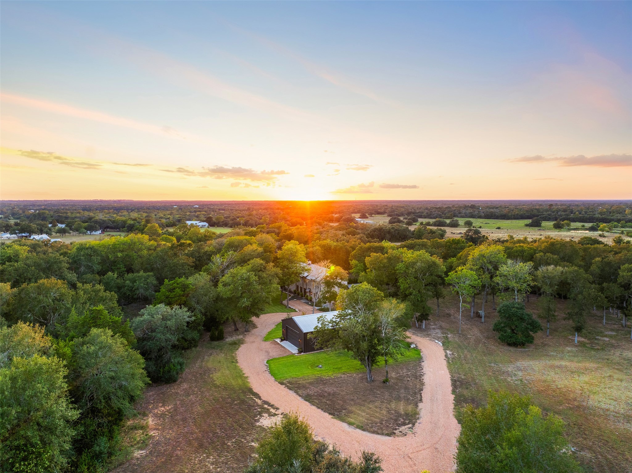 565 Bybee Road Round Top, TX 78954 - Photo 29 of 30 an aerial view of green landscape with trees houses and mountain view