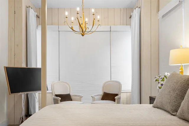 a bedroom with a bed and a television