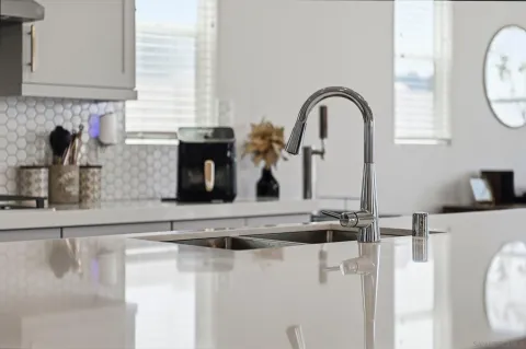 a kitchen with stainless steel appliances granite countertop a sink a stove top oven a wooden floors