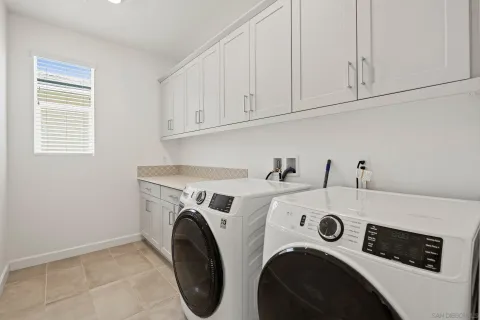 an aerial view of residential houses with outdoor space and parking