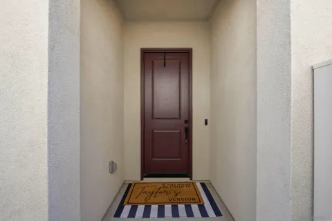 a large white kitchen with lots of counter space a sink appliances and a dining table