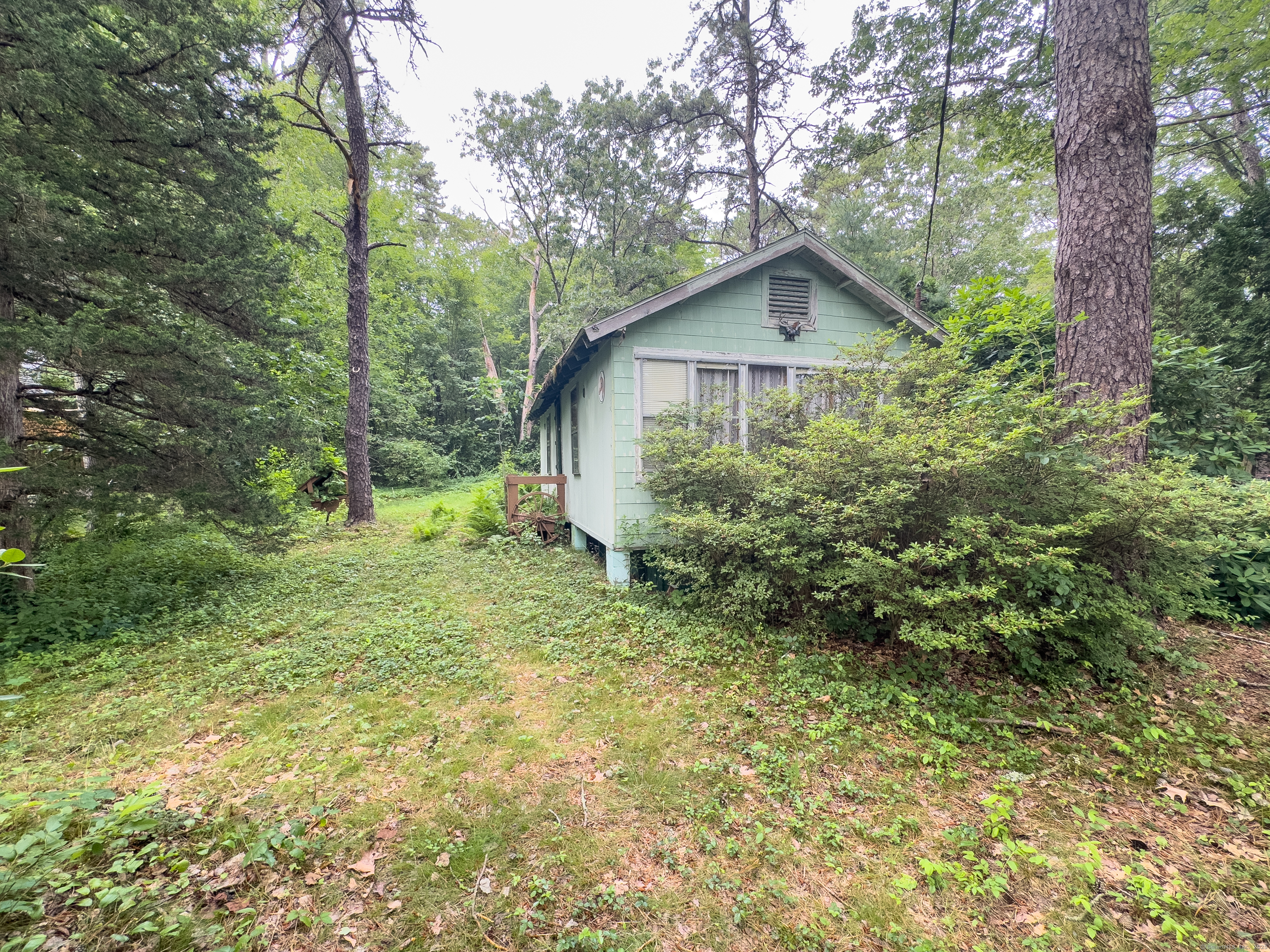 28 Pleasant View Street Lisbon, CT 06351 - Photo 8 of 8 a view of a house with a small yard and large trees