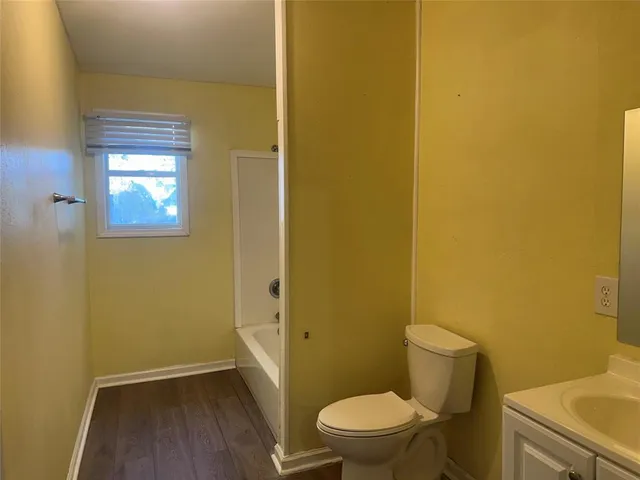 a white toilet sitting next to a small sink
