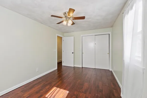 a view of an empty room with wooden floor
