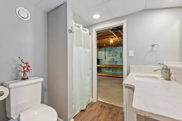 a bathroom with a toilet sink and mirror