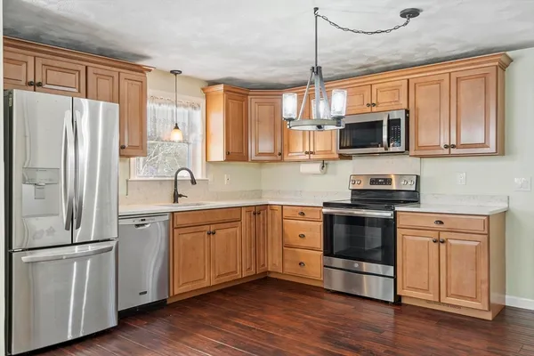 a kitchen with stainless steel appliances granite countertop a refrigerator stove microwave and sink