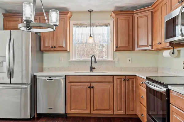 a kitchen with stainless steel appliances granite countertop a sink stove and microwave