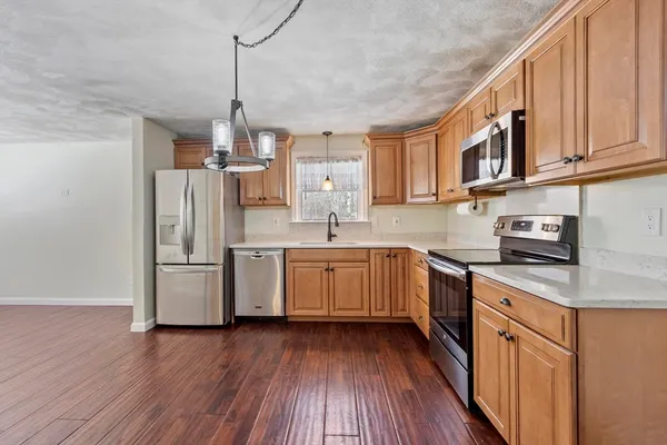 a kitchen with refrigerator and cabinets
