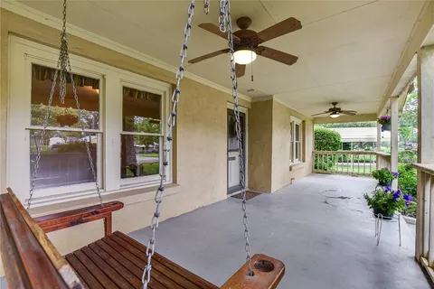 a living room with hardwood floor and a ceiling fan