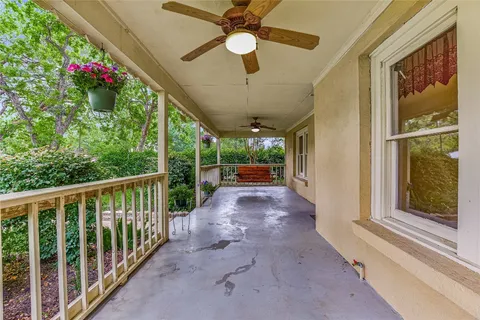 a view of a porch with a flower garden