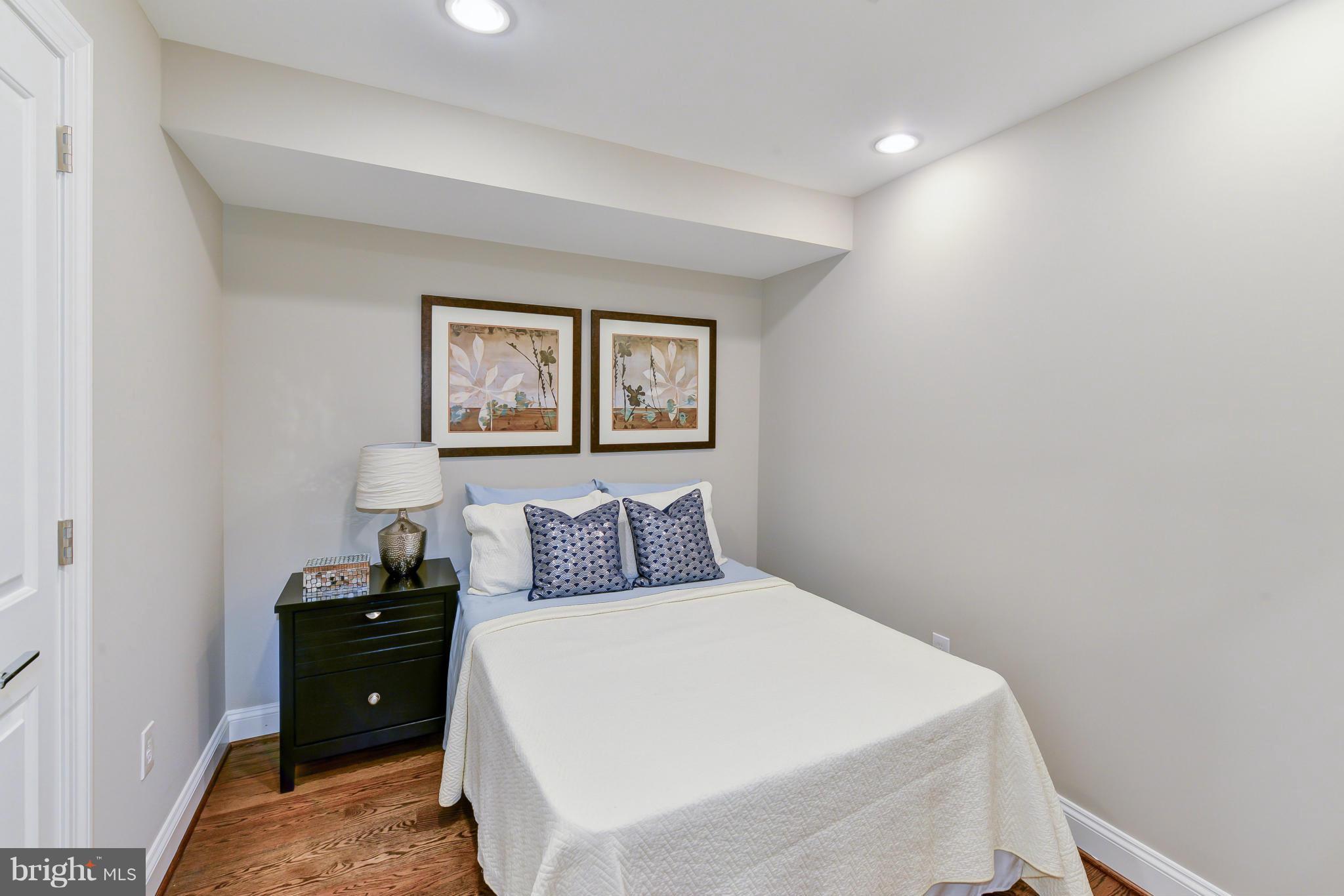 1823 S Street Northwest, Unit 3 Washington, DC 20009 - Photo 13 of 24 a bedroom with a bed and a painting on the wall