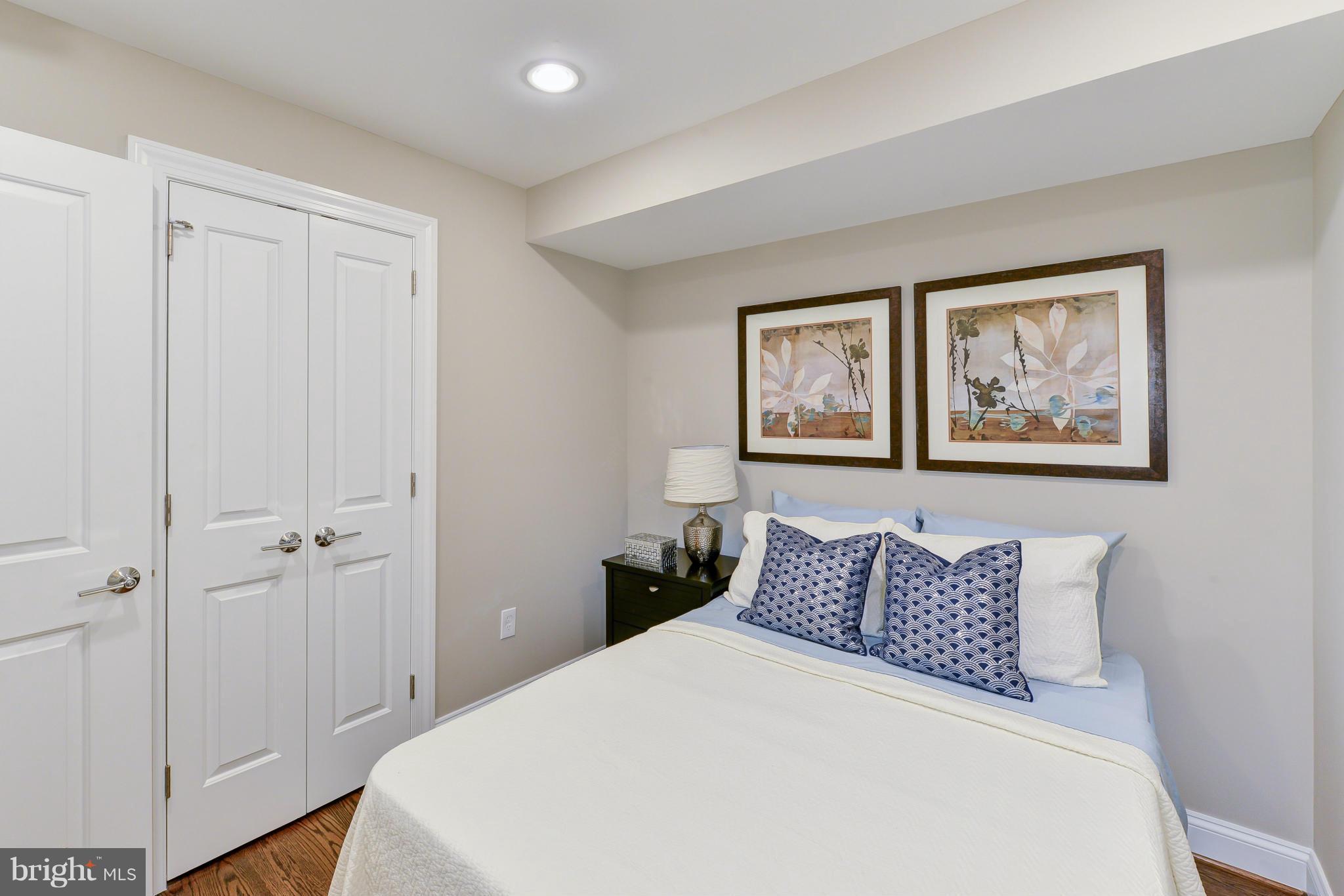 1823 S Street Northwest, Unit 3 Washington, DC 20009 - Photo 14 of 24 a bed room with a bed and a painting on the wall