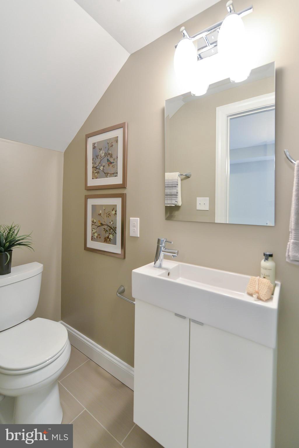 1823 S Street Northwest, Unit 3 Washington, DC 20009 - Photo 15 of 24 a bathroom with a toilet sink and mirror