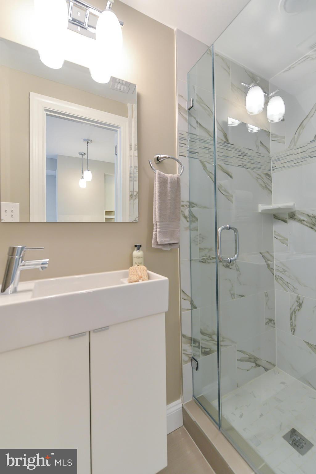 1823 S Street Northwest, Unit 3 Washington, DC 20009 - Photo 16 of 24 a bathroom with a sink a toilet and shower