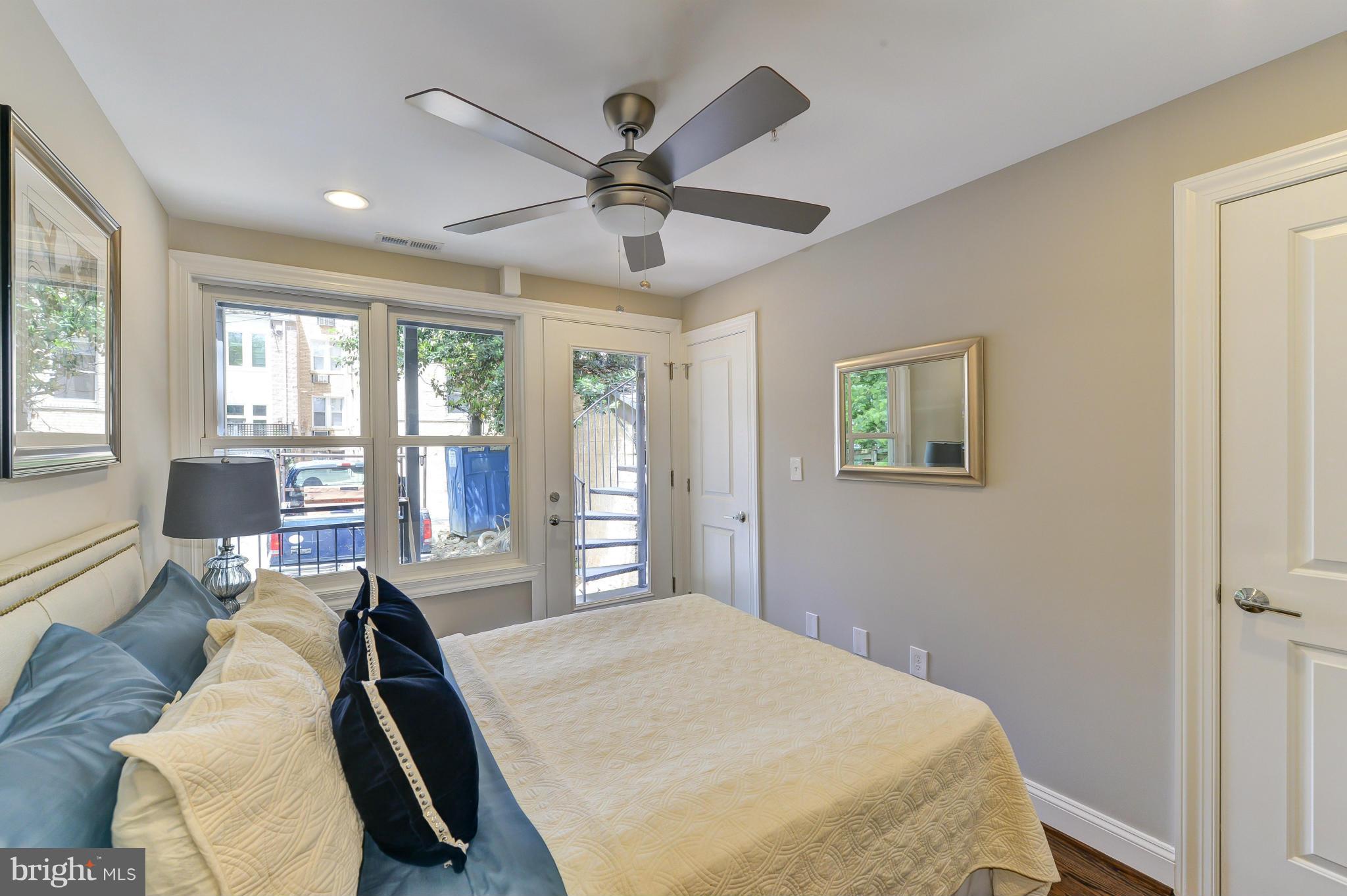 1823 S Street Northwest, Unit 3 Washington, DC 20009 - Photo 17 of 24 a bedroom with a bed and glass window