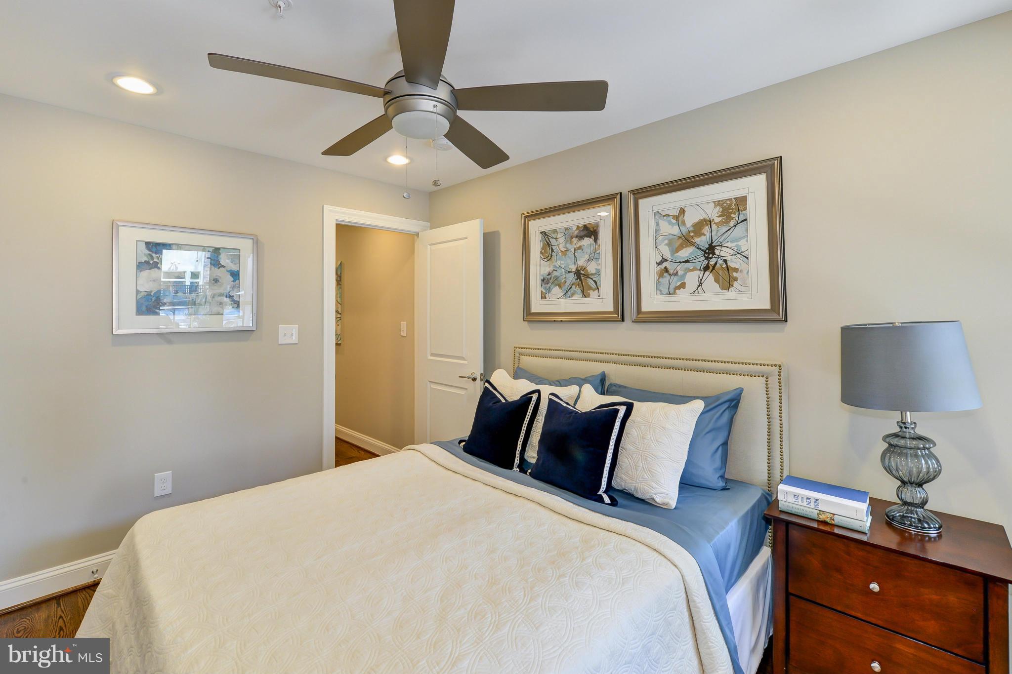1823 S Street Northwest, Unit 3 Washington, DC 20009 - Photo 20 of 24 a bedroom with a bed and a lamp on the dresser