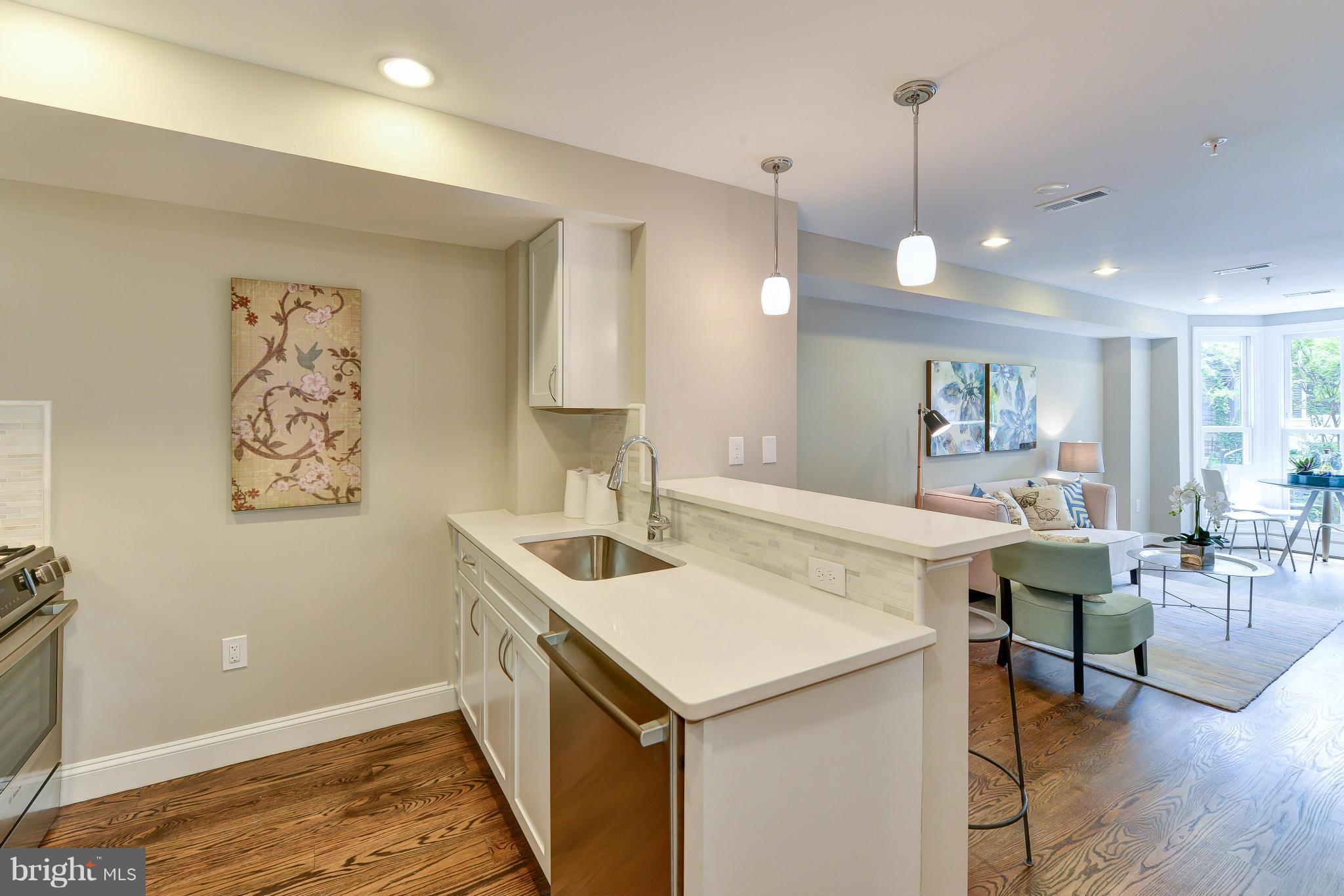 1823 S Street Northwest, Unit 3 Washington, DC 20009 - Photo 10 of 24 a view of kitchen island a sink a table and chairs