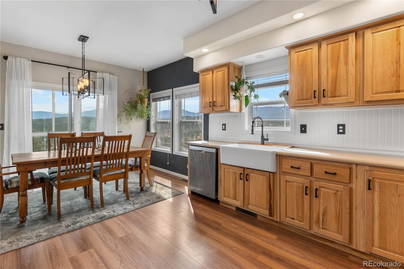 147 Overlook Drive Bailey, CO 80421 - Photo 12 of 43 a dining room with stainless steel appliances granite countertop a couch a table and chairs with wooden floor