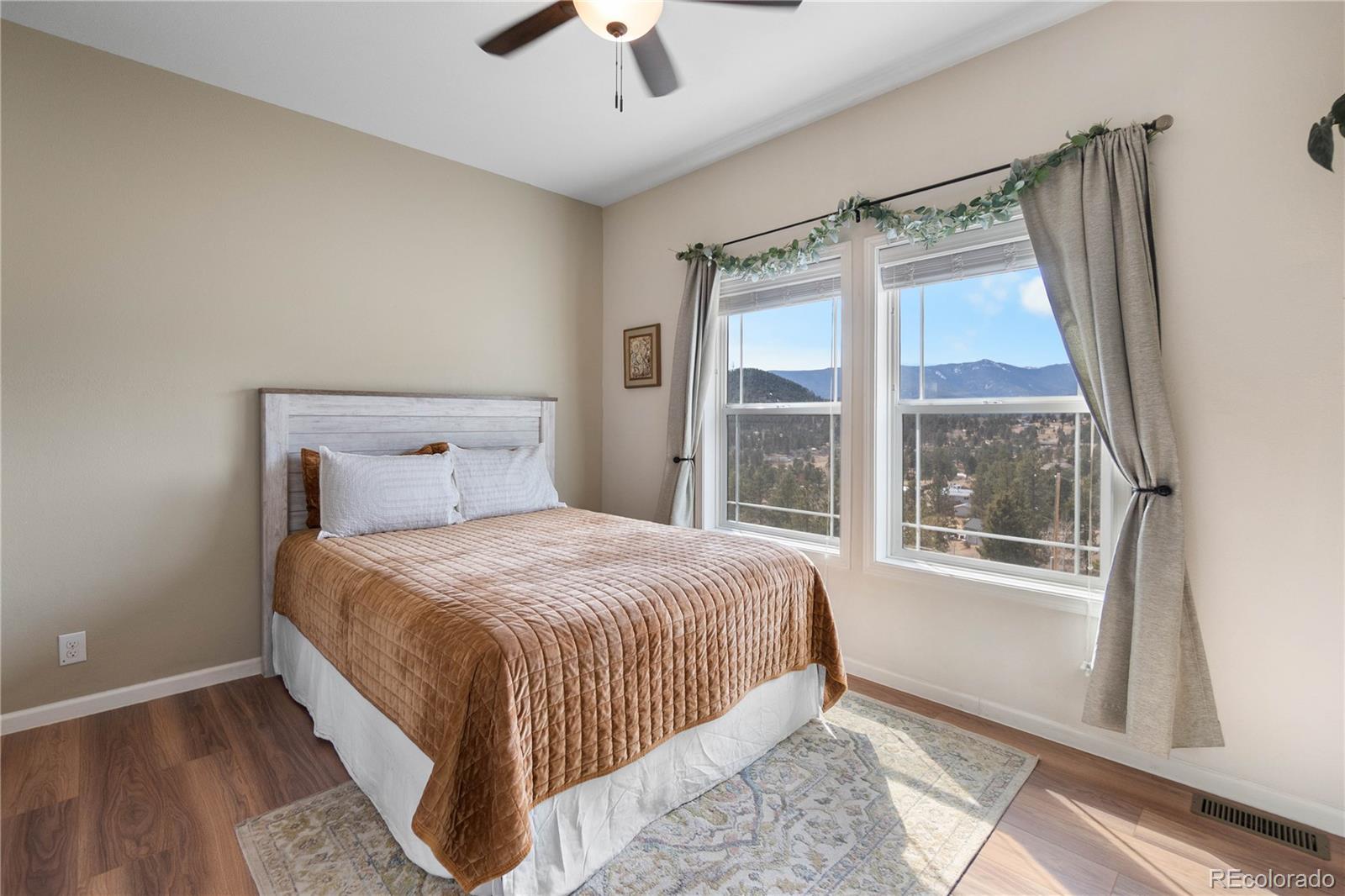 147 Overlook Drive Bailey, CO 80421 - Photo 15 of 43 a bedroom with a large bed and a large window