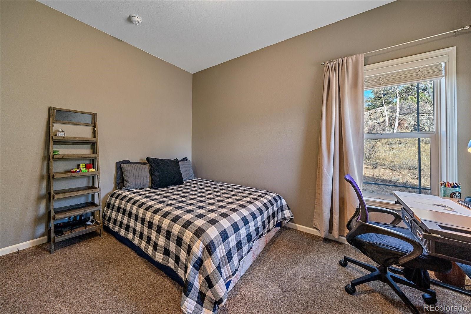 147 Overlook Drive Bailey, CO 80421 - Photo 20 of 43 a bedroom with a bed and a desk