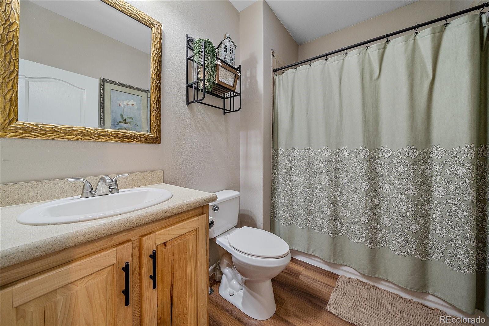 147 Overlook Drive Bailey, CO 80421 - Photo 22 of 43 a bathroom with a granite countertop toilet sink and mirror