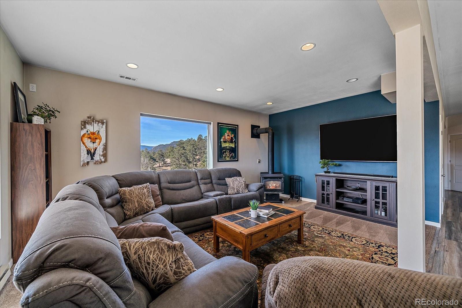 147 Overlook Drive Bailey, CO 80421 - Photo 25 of 43 a living room with furniture and a flat screen tv
