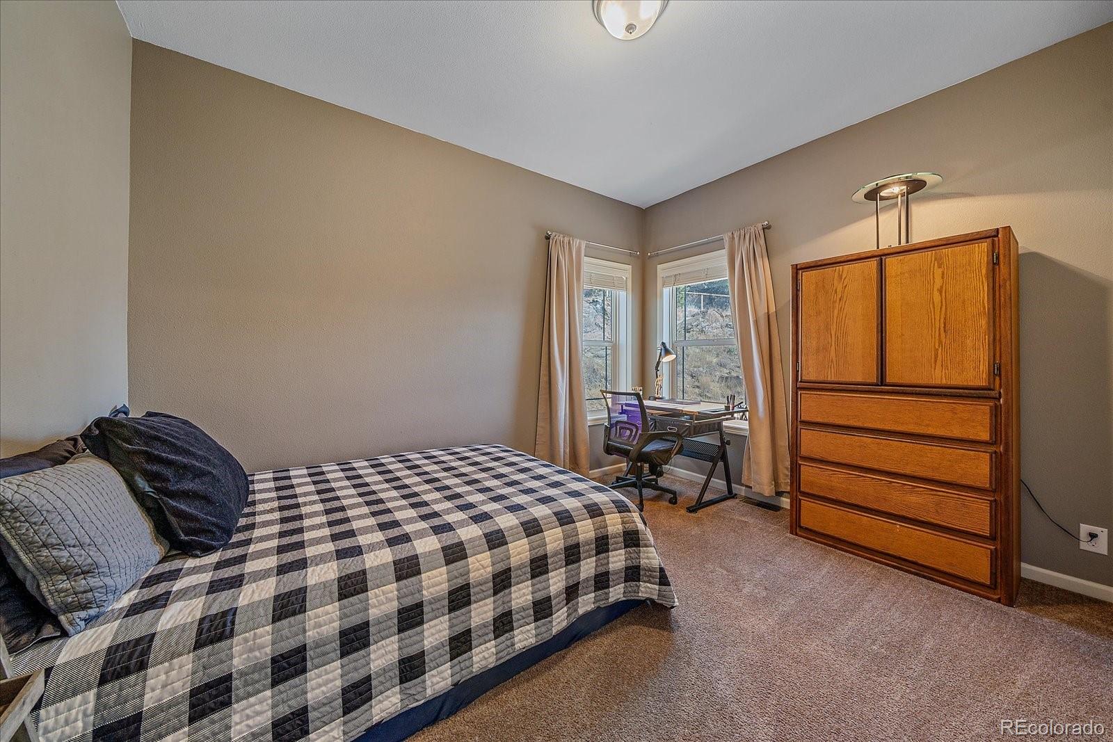147 Overlook Drive Bailey, CO 80421 - Photo 27 of 43 a bedroom with a bed and a window