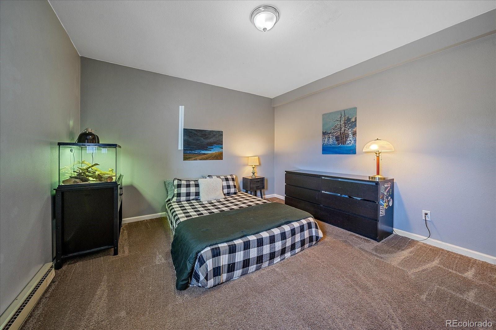 147 Overlook Drive Bailey, CO 80421 - Photo 28 of 43 a bedroom with a bed and a lamp on table
