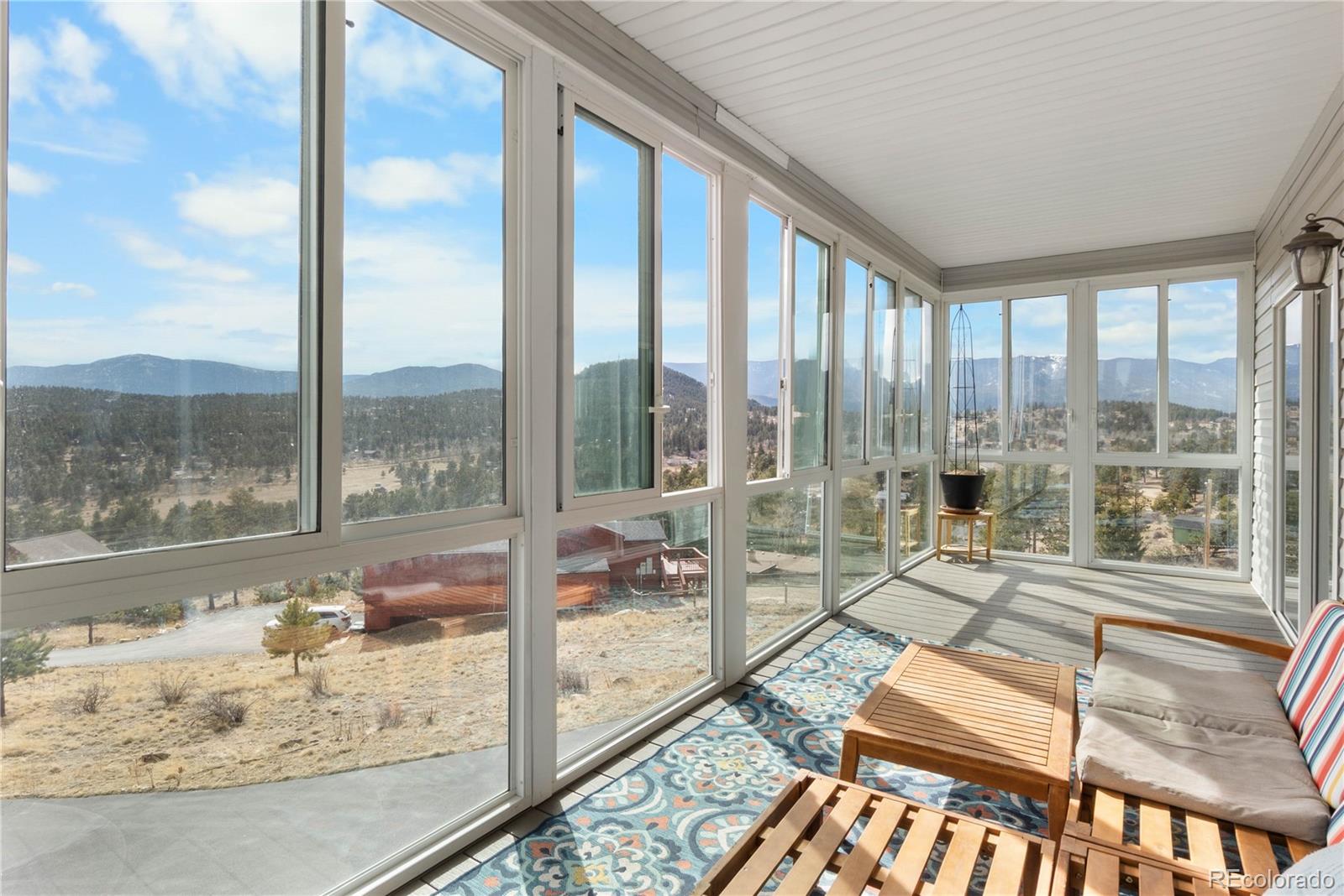 147 Overlook Drive Bailey, CO 80421 - Photo 3 of 43 a living room with a large window and table
