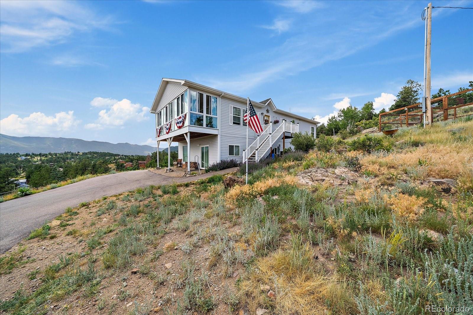 147 Overlook Drive Bailey, CO 80421 - Photo 35 of 43 a front view of a house with a yard