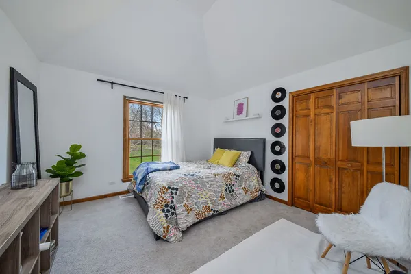 a bedroom with bed and a window