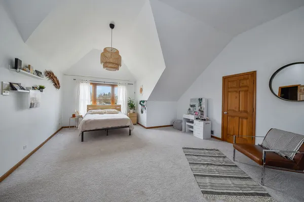 a bedroom with furniture and a window