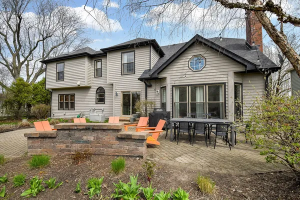 a view of a house with backyard sitting area and garden
