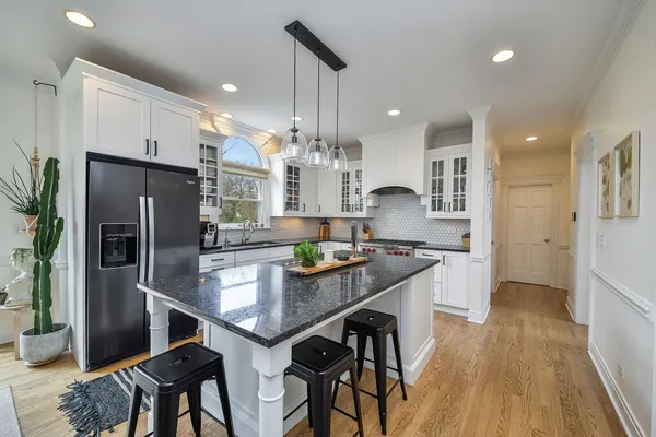a kitchen with stainless steel appliances granite countertop counter space and wooden floor