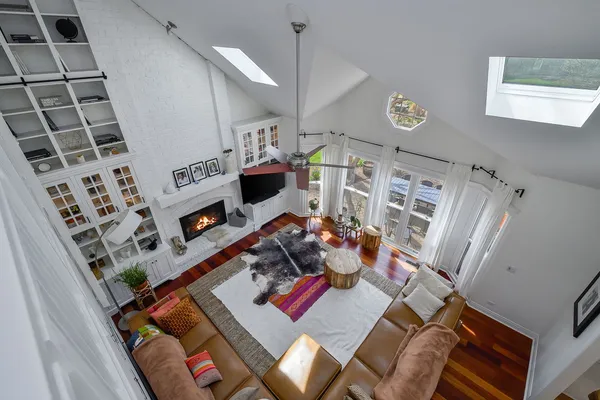 a living room with furniture and wooden floor