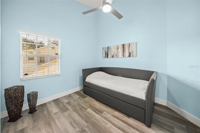 a bedroom with a bed and a window