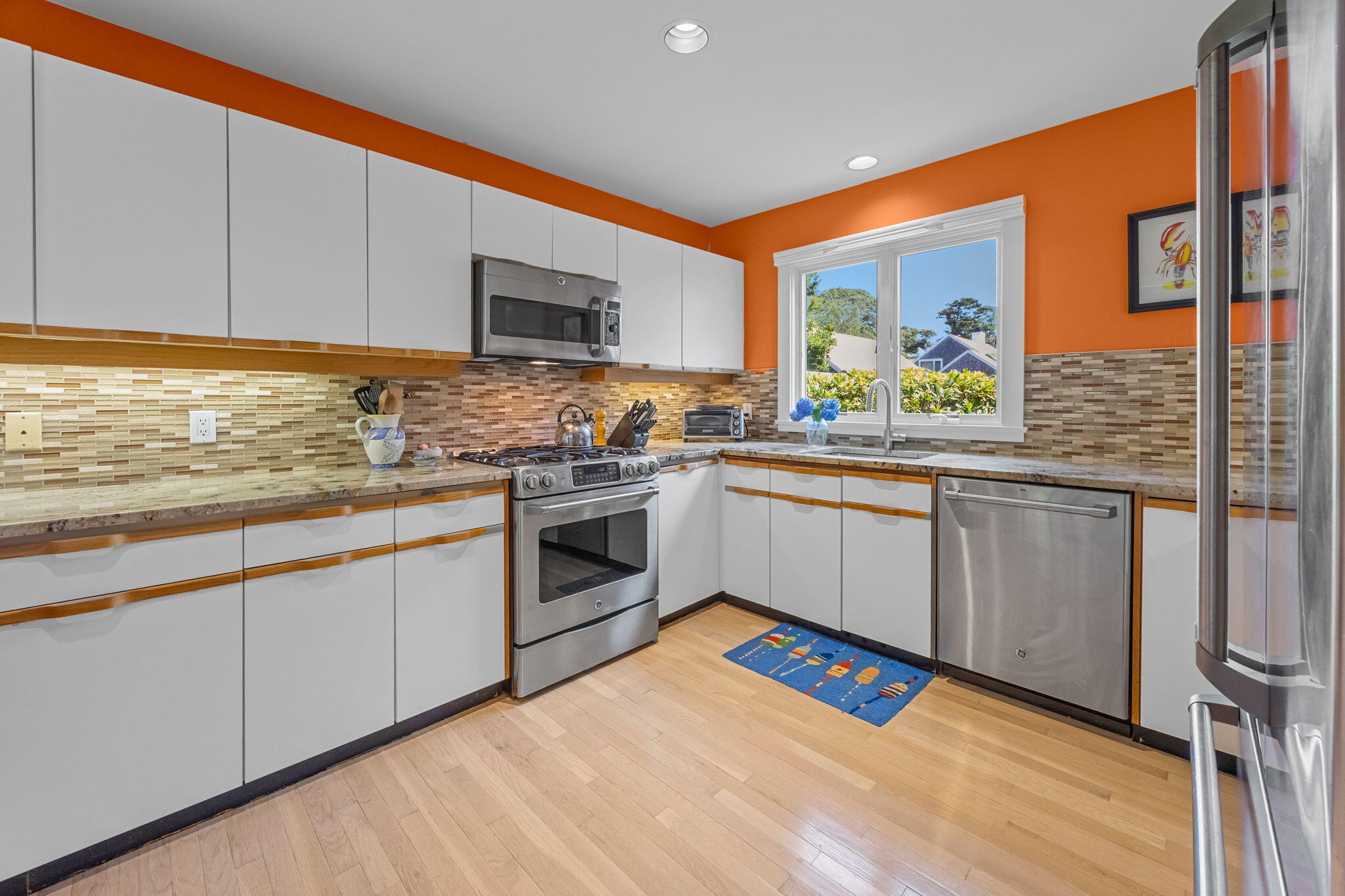 11 Juniper Circle, Unit 11 Brewster, MA 02631 - Photo 13 of 52 a kitchen with stainless steel appliances granite countertop a stove a sink and a microwave