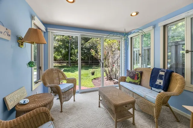 a living room with furniture and a floor to ceiling window