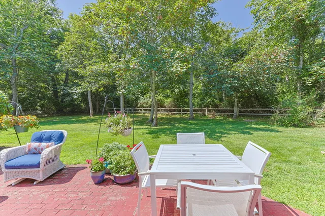a front view of house with yard and outdoor seating