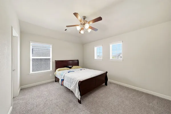 a bedroom with a bed and window