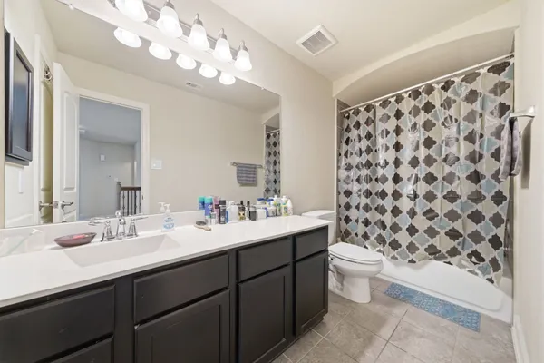 a bathroom with a sink toilet and a mirror