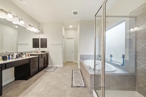a large bathroom with a large tub and sink