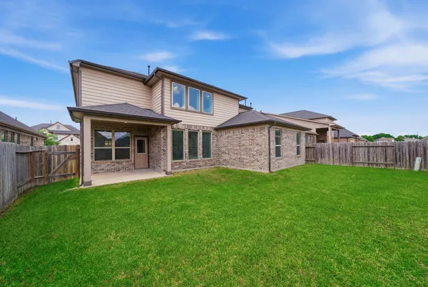 a view of a house with a yard and deck