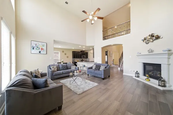 a living room with furniture fireplace and a chandelier