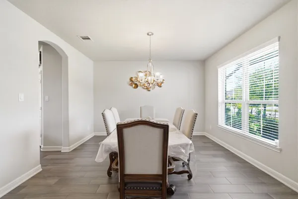 a dining room with furniture and window