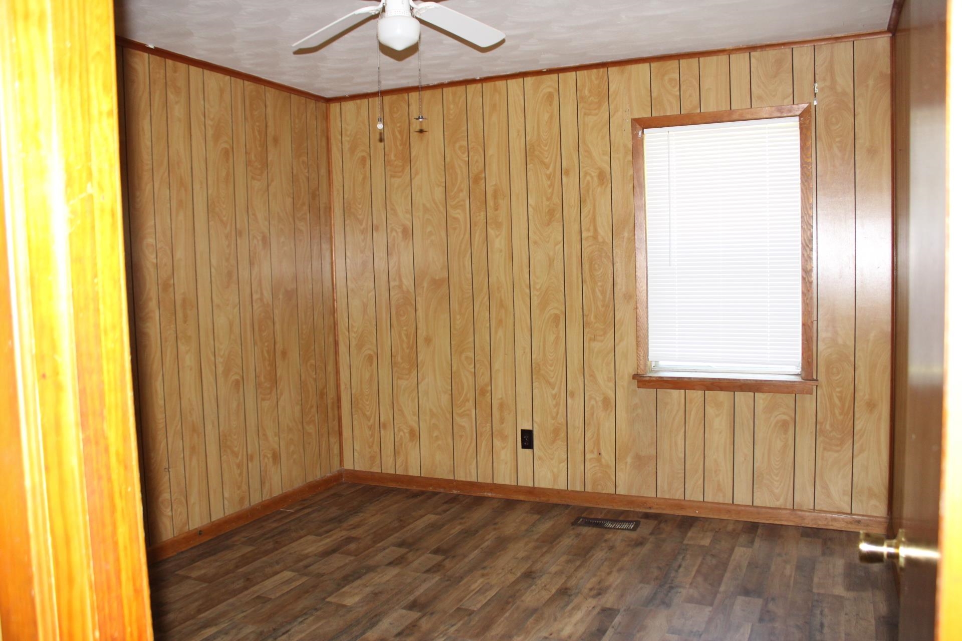 584 Chisholm Lake Road Ripley, TN 38063 - Photo 12 of 28 a view of a hallway with wooden floor and a window