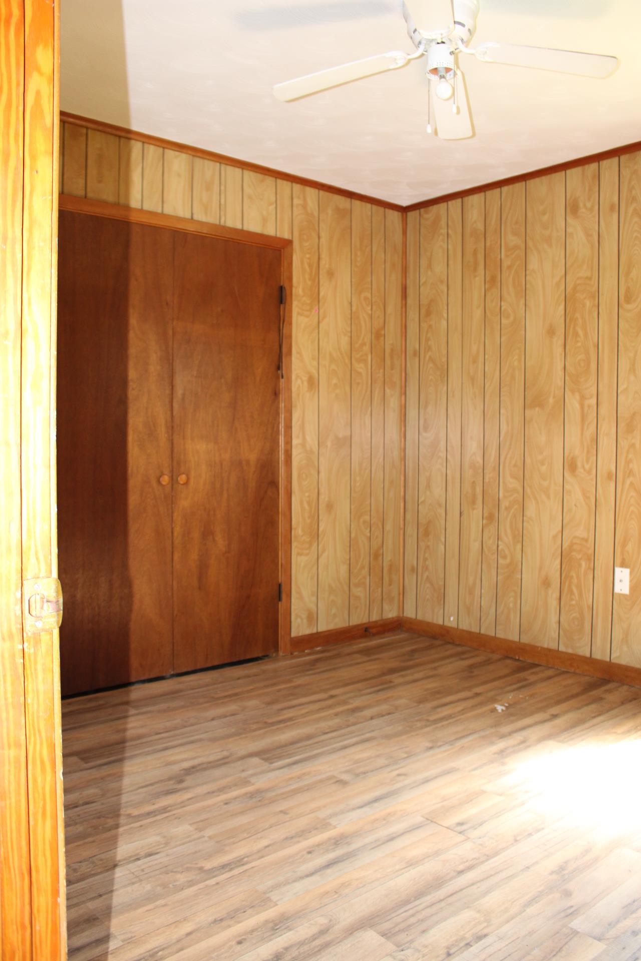 584 Chisholm Lake Road Ripley, TN 38063 - Photo 17 of 28 an empty room with wooden floor and windows