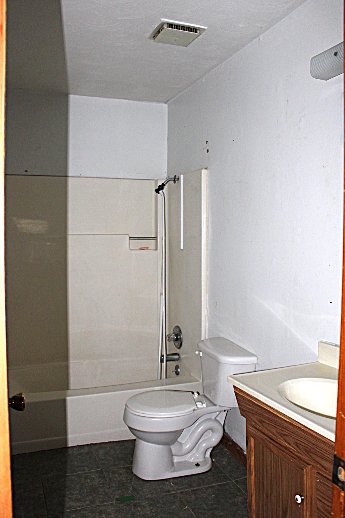 584 Chisholm Lake Road Ripley, TN 38063 - Photo 18 of 28 a bathroom with a toilet a sink and shower